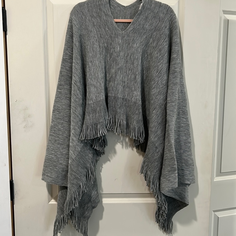 Pullover Poncho with fringe trim. One Size